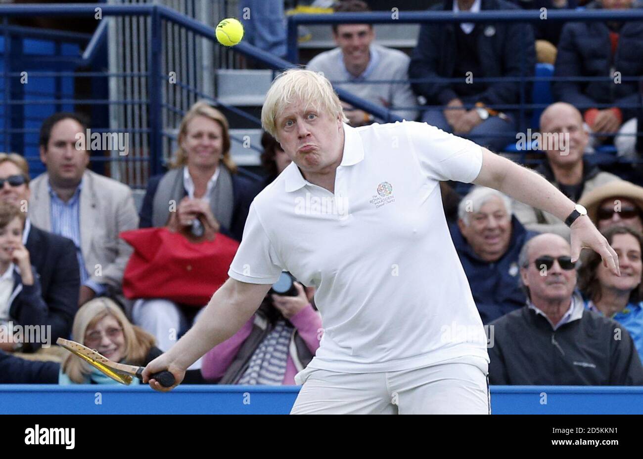 Boris Johnson (centre) takes part in a celebrity tennis match in aid of the Royal Marsden Hospital at The Queen's Club, London.  Stock Photo
