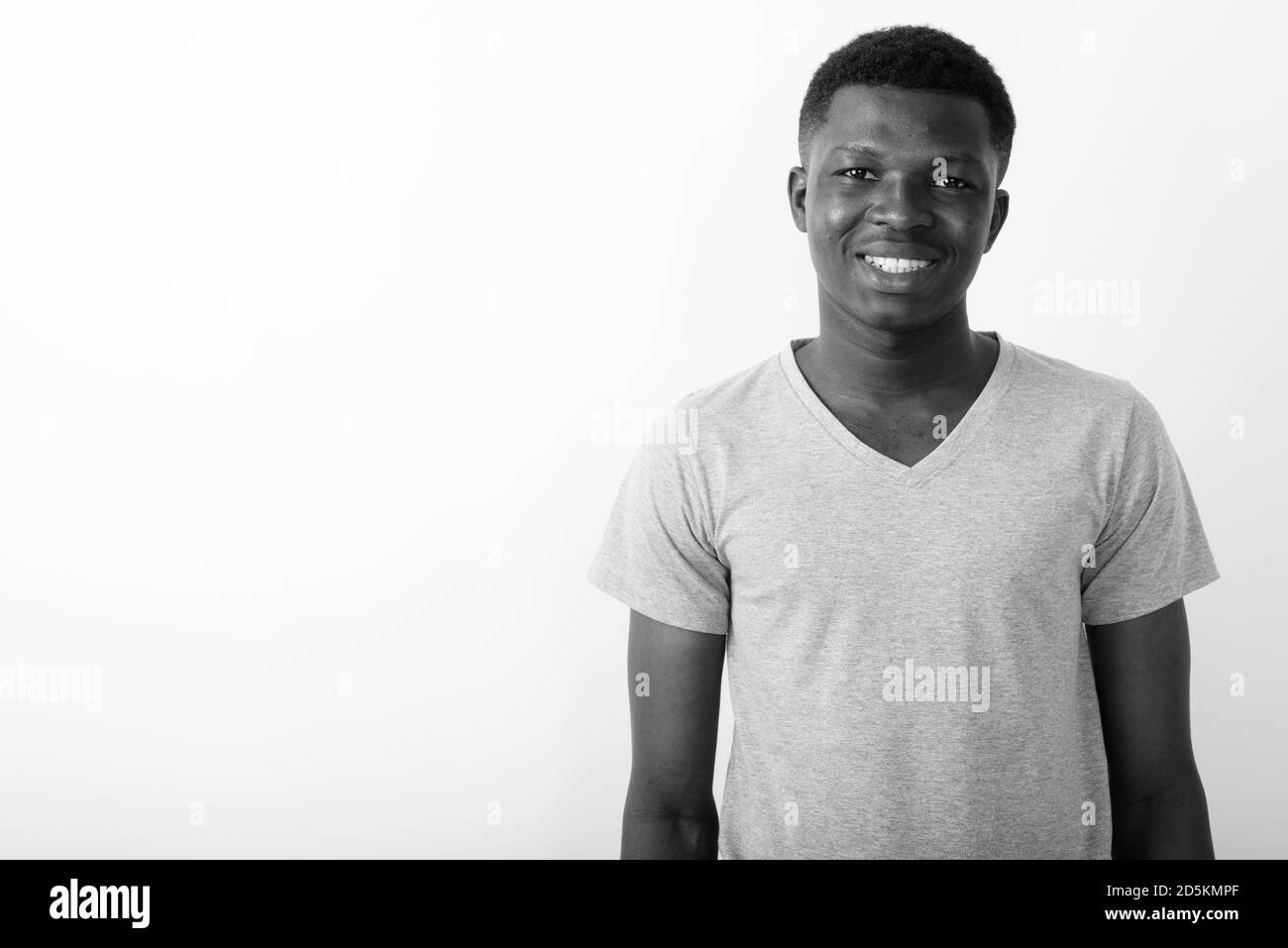 Studio shot of young happy black African man smiling against white ...