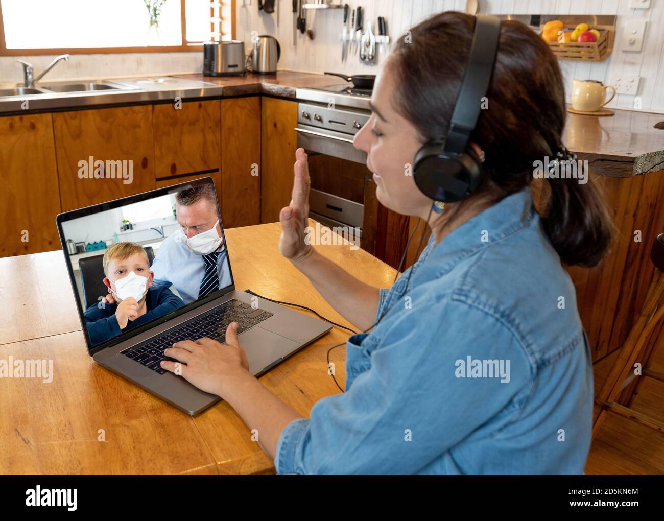 Primary Teacher video calling student young child and parent in self isolation after being tested positive for COVID-19. Reopening of Schools, online Stock Photo