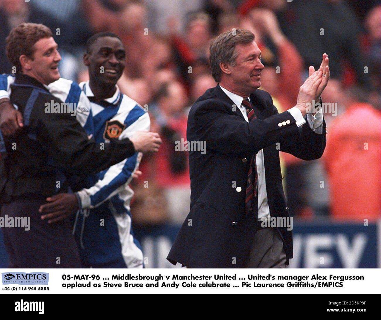 Manchester United's manager Alex Ferguson applauds as Steve Bruce and Andy Cole celebrate  Stock Photo