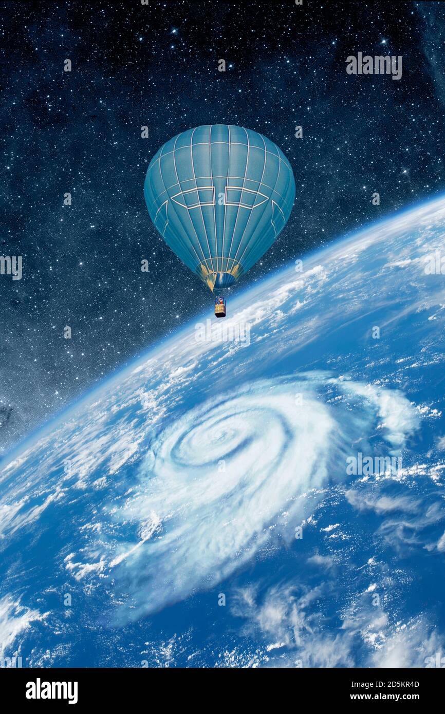 High flying hot air balloon escaping Earth and cyclone aiming high concept Stock Photo