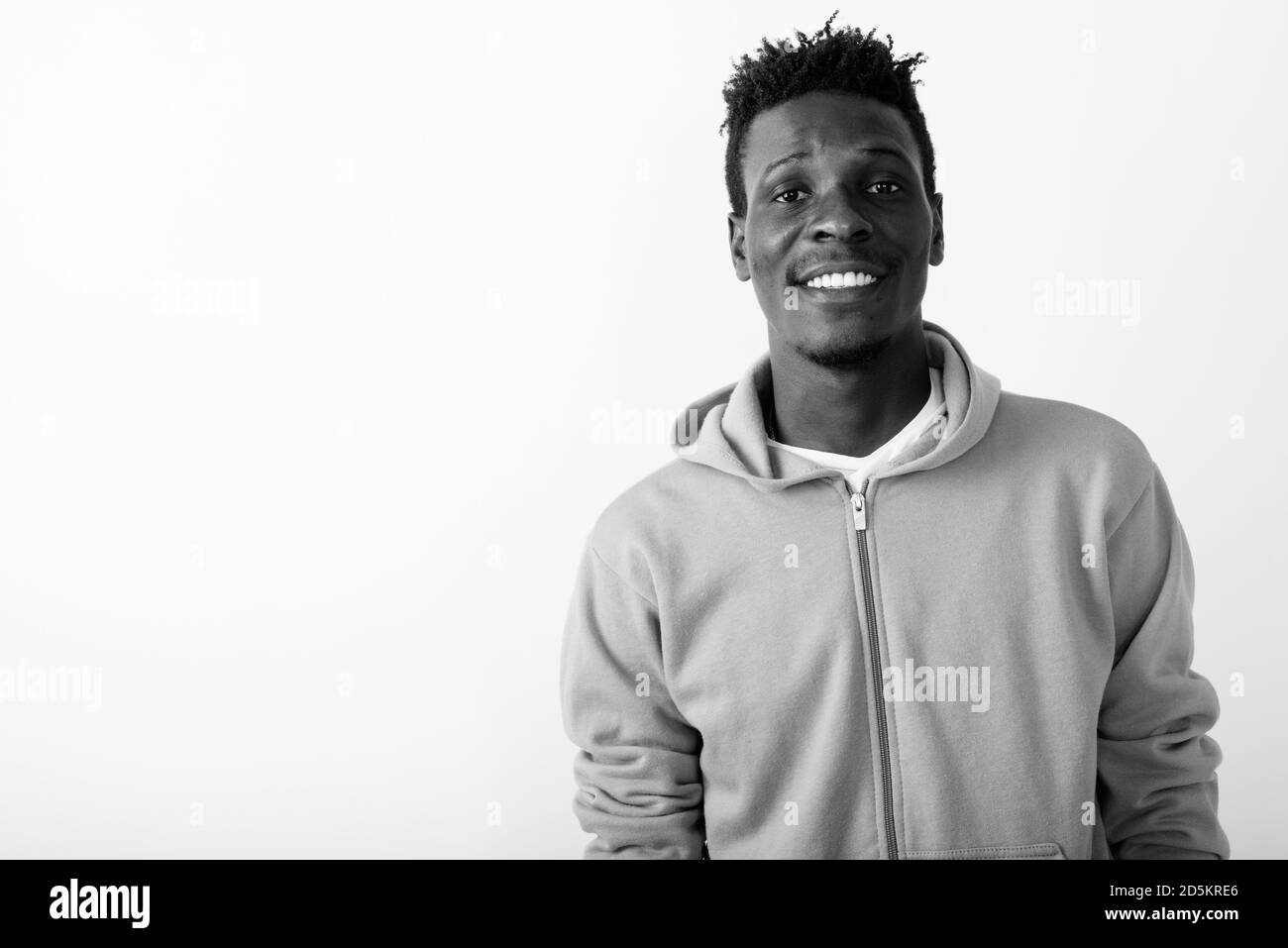 Close up of young happy black African man smiling against white ...