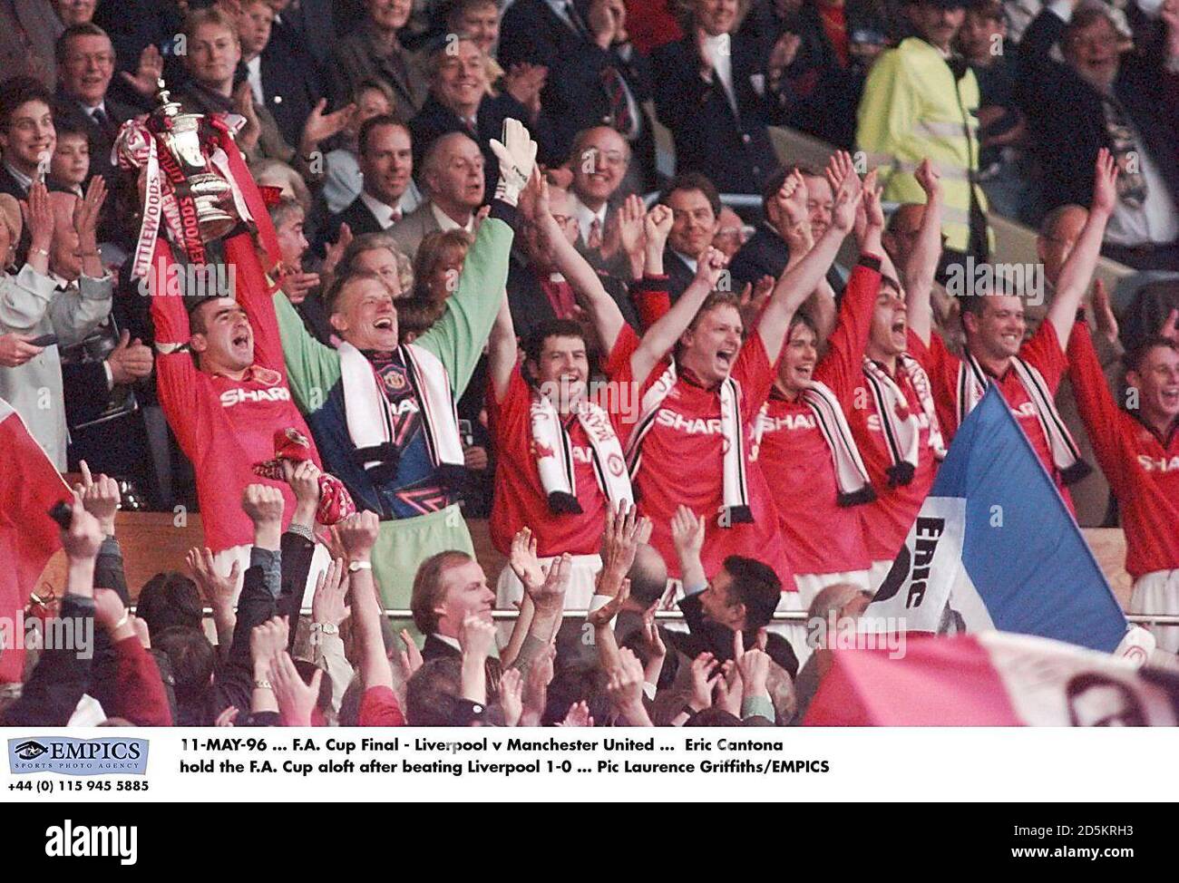 Eric Cantona hold the FA Cup aloft after his goal beat Liverpool 1-0, as his teammates celebrate; (l-r) Cantona, Peter Schmeichel, Denis Irwin, David May, David Beckham, Gary Neville, Gary Pallister, Nicky Butt. Stock Photo
