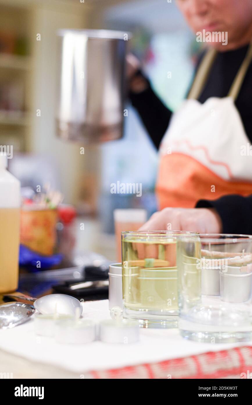 Creative occupation of candle making showing the pouring of liquid wax