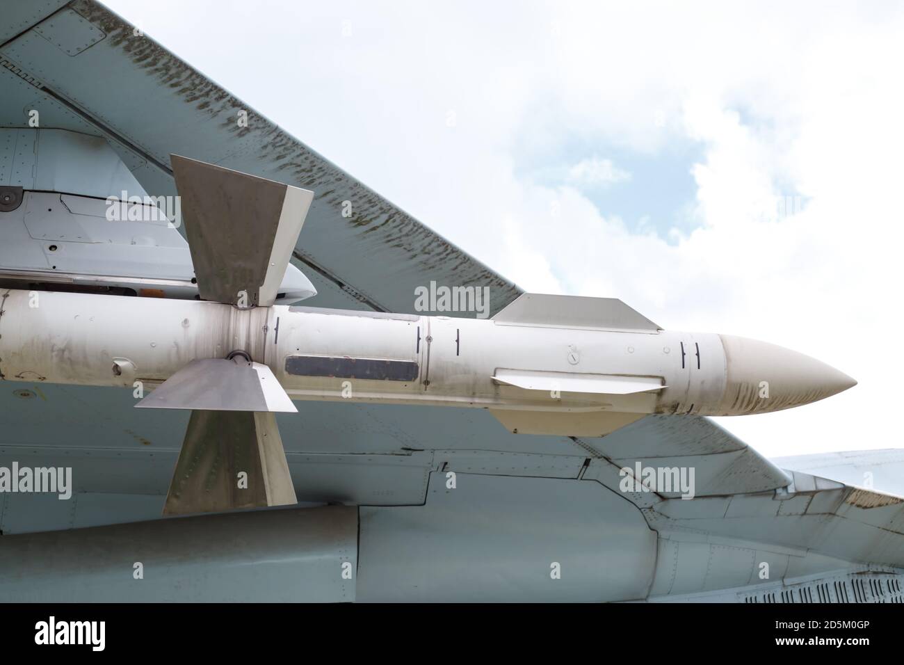 The air-to-air missile is suspended under the wing of the aircraft. Fragment of the plane Stock Photo