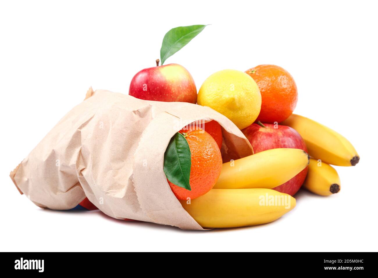 Fresh bananas, lemon, tangerines, apples in a paper bag isolated on white background Stock Photo