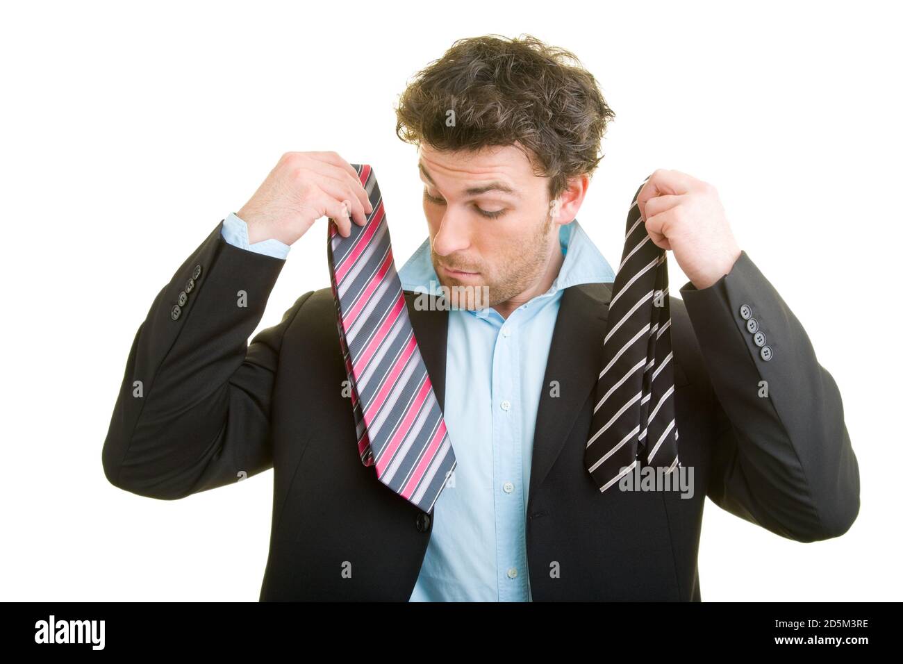 Young man in a suit decides on a tie Stock Photo