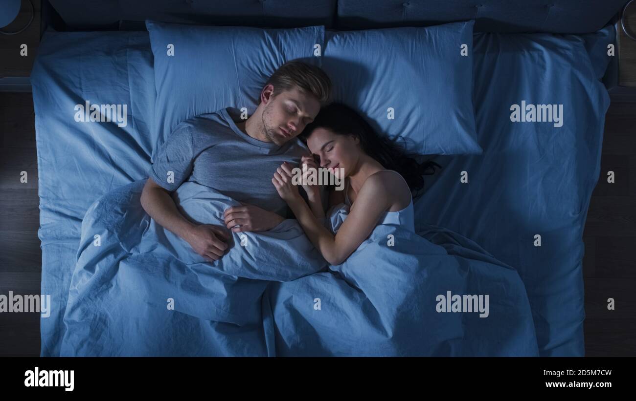 Happy couple in love sleeping together at home Stock Photo - Alamy