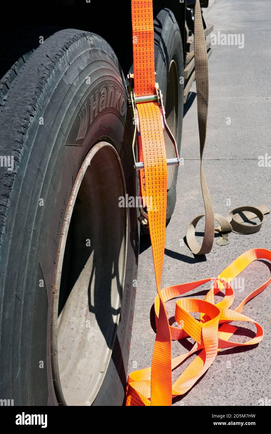 Closeup isolated view of new orange lashing straps next to old ones