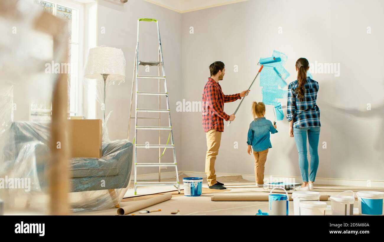 Beautiful Young Family are Showing How to Paint Walls to Their Adorable ...