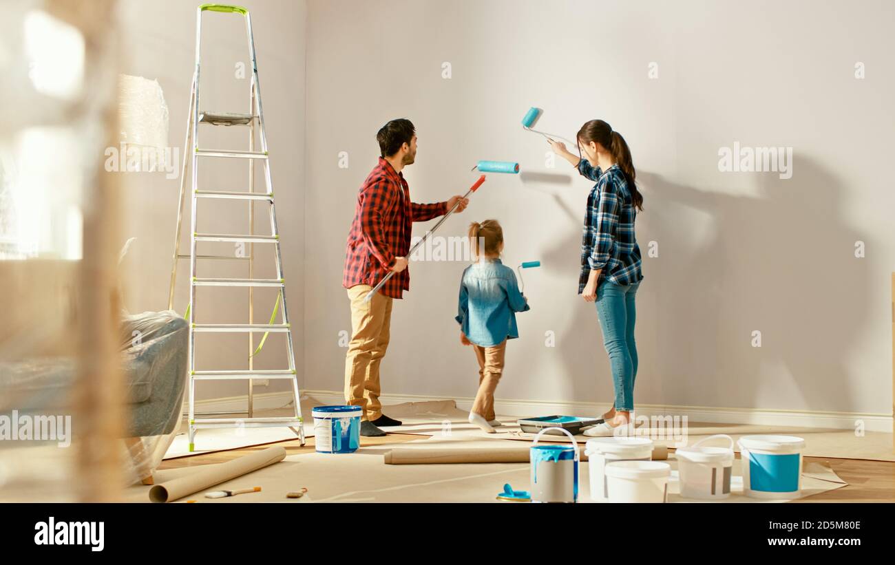 Beautiful Young Family are Showing How to Paint Walls to Their Adorable ...