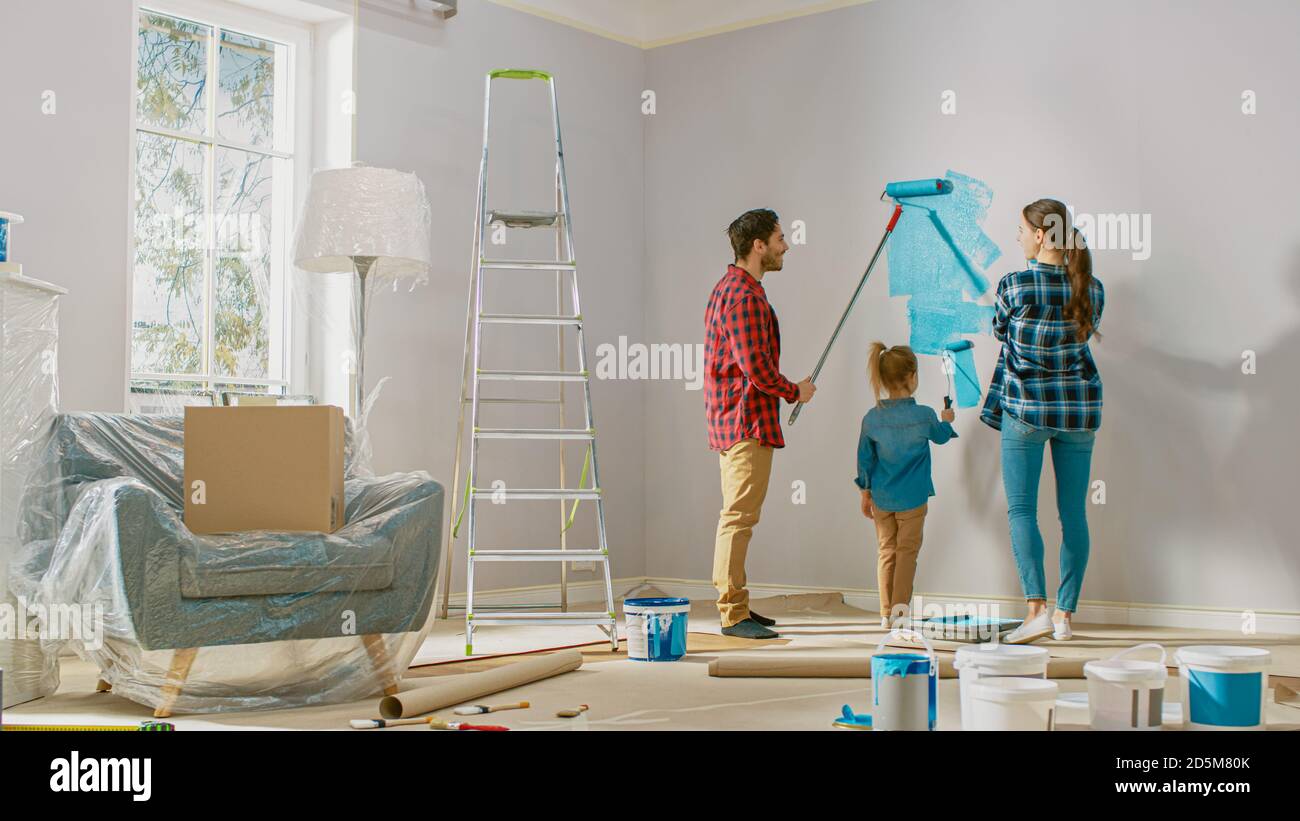 Beautiful Young Family are Showing How to Paint Walls to Their Adorable ...