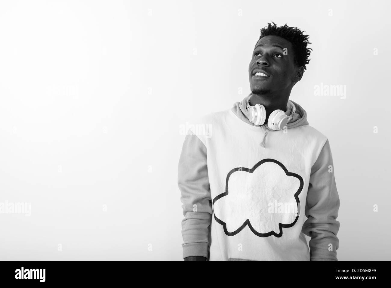 Studio shot of young happy black African man smiling and thinking Stock ...