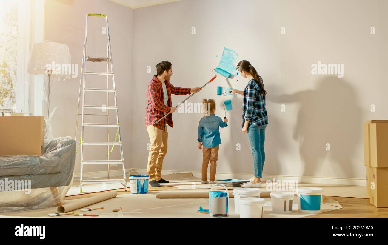 Beautiful Young Family are Showing How to Paint Walls to Their Adorable