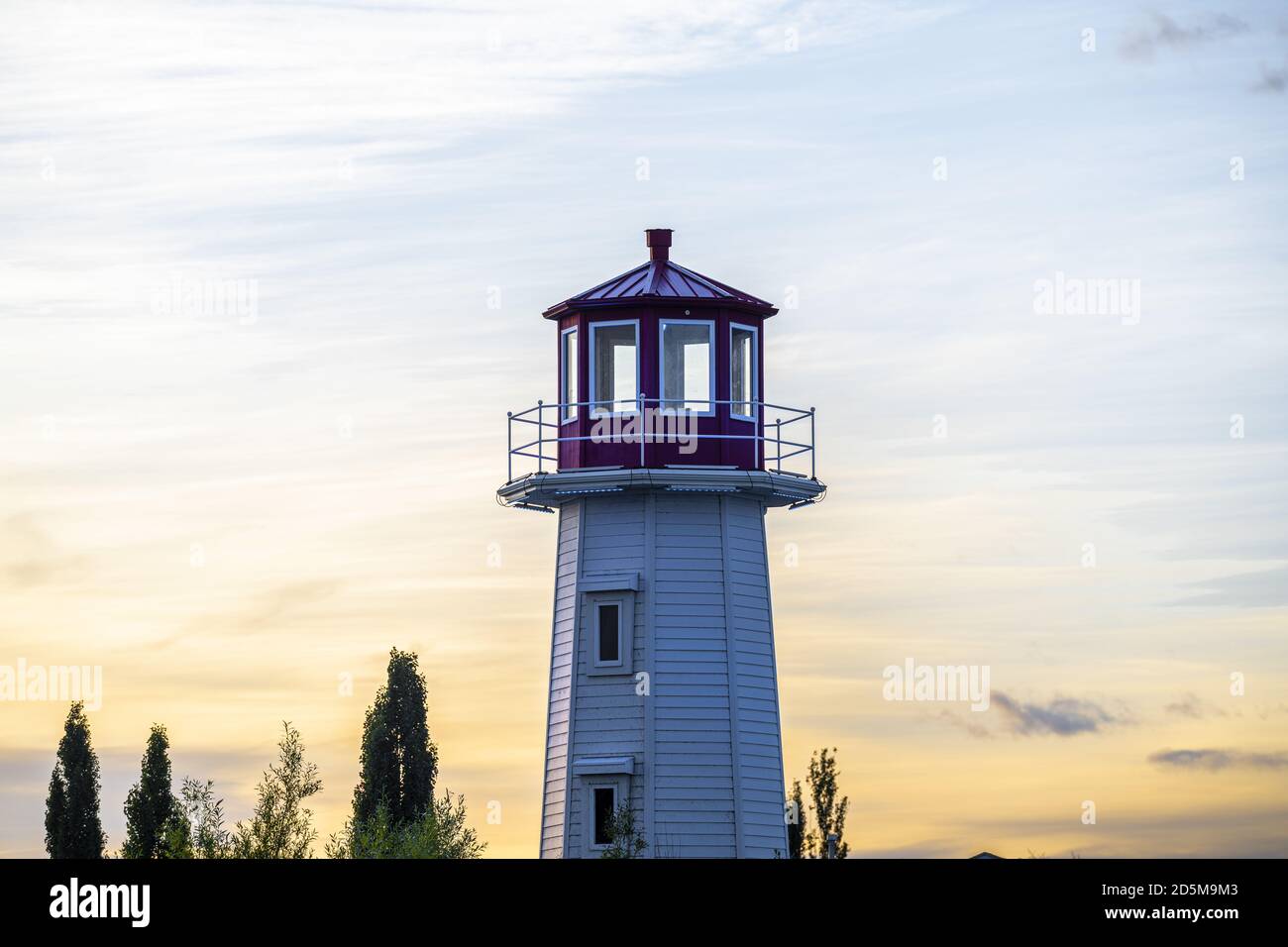 Tall lighthouse during sunset near Sylvan Lake in Alberta, Canada Stock Photo