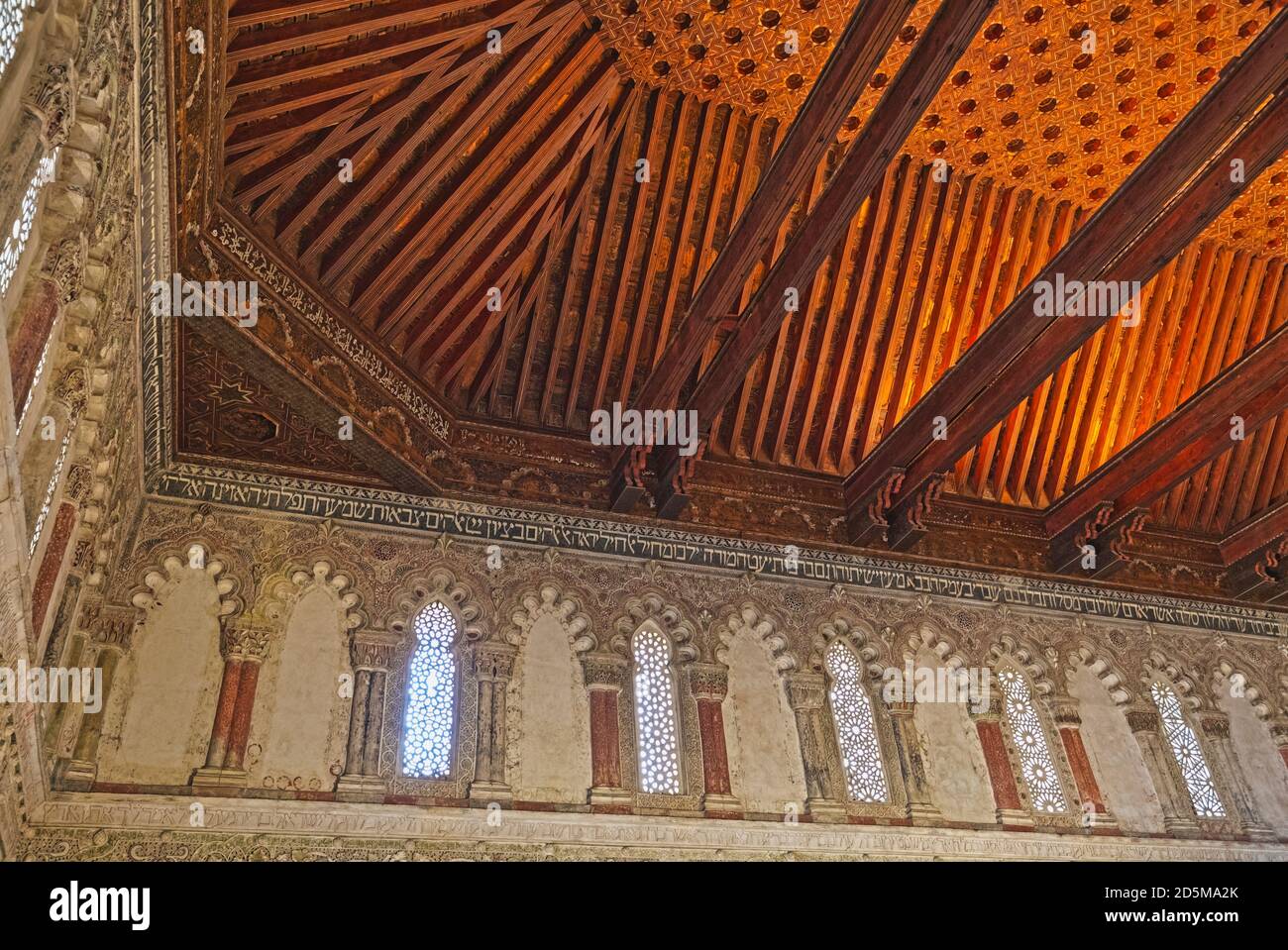 Intricately patterned wooden artesonado ceiling and stucco decoration.  Synagogue of El Tránsito (Sinagoga del Tránsito), founded in the 1350’s. Toled Stock Photo