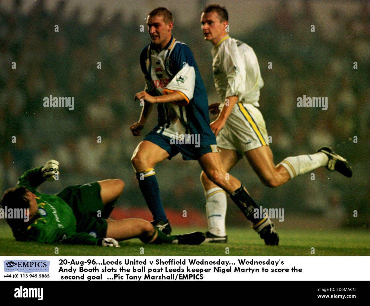 20-Aug-96. Leeds United v Sheffield Wednesday.  Wednesday's Andy Booth (centre) slots the ball past Leeds keeper Nigel Martyn to score the second goal Stock Photo