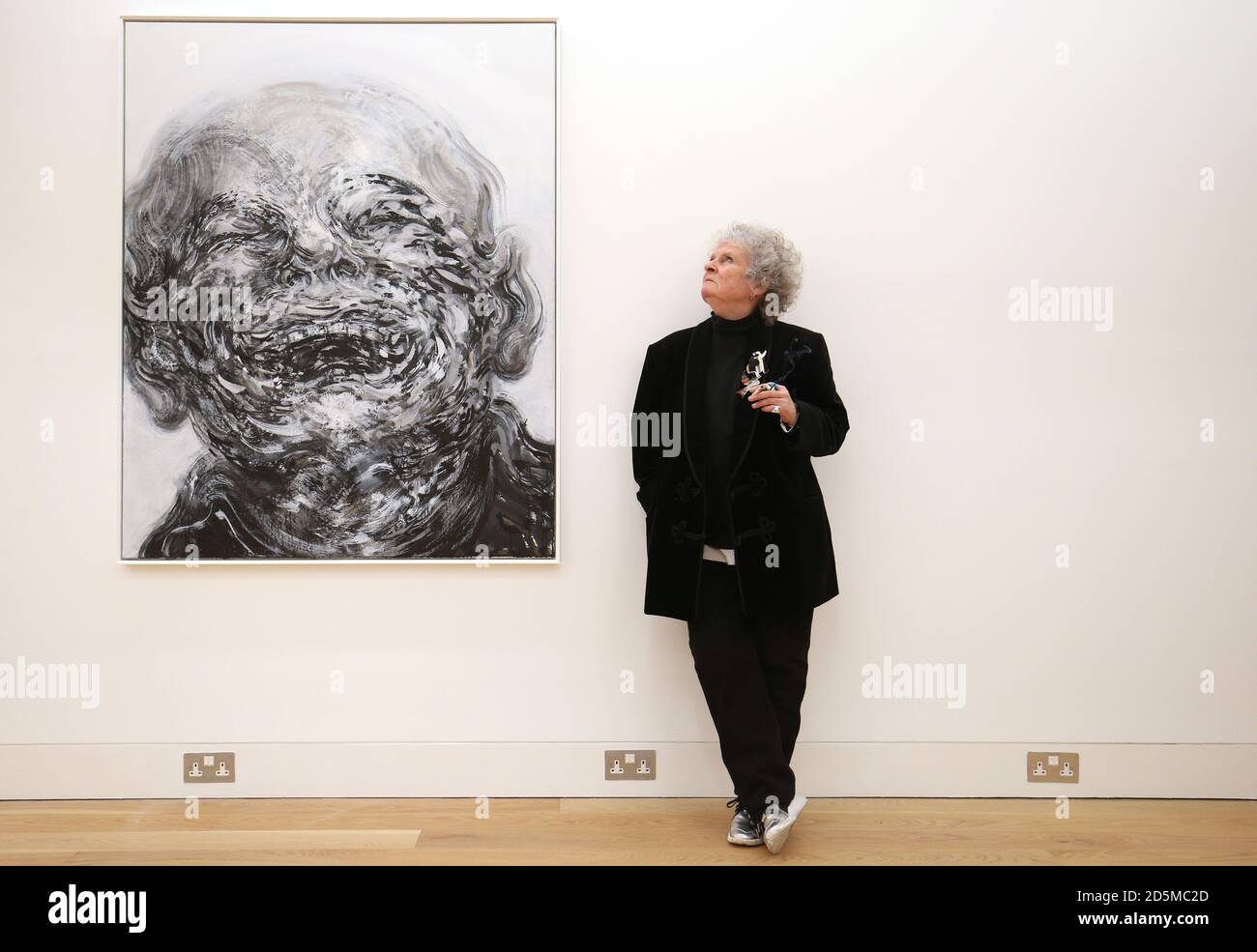 British artist Maggi Hambling stands next to her work 'Laughing' whilst attending her new exhibition at the Marlborough Gallery, London. Stock Photo
