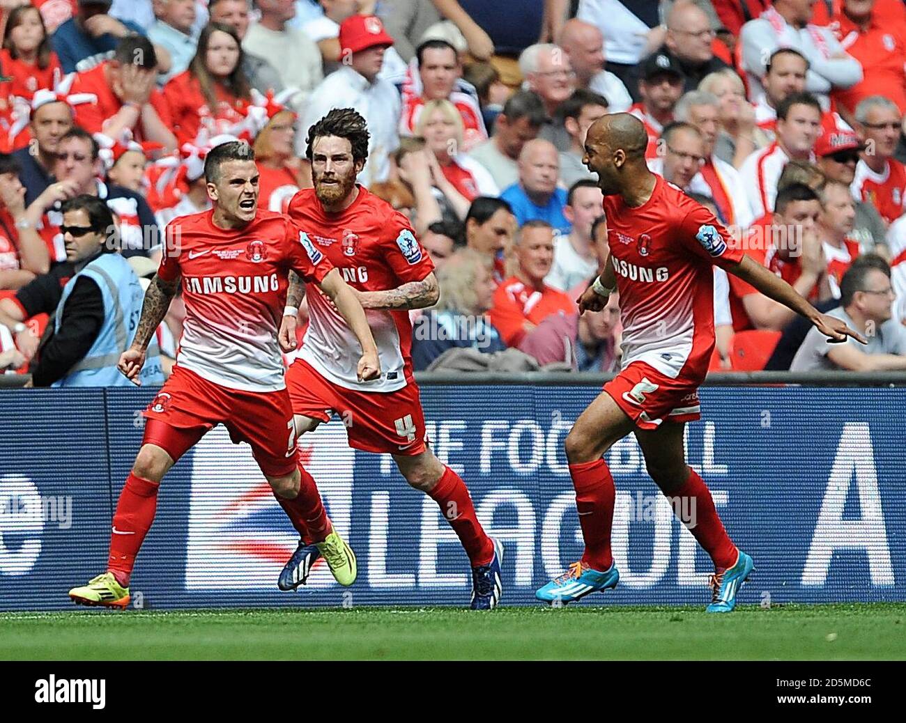 Leyton Orient's Dean Cox (left) celebrates scoring his teams second goal of the game with teammates Romain Vincelot (centre) and Elliot Omozusi (right) Stock Photo