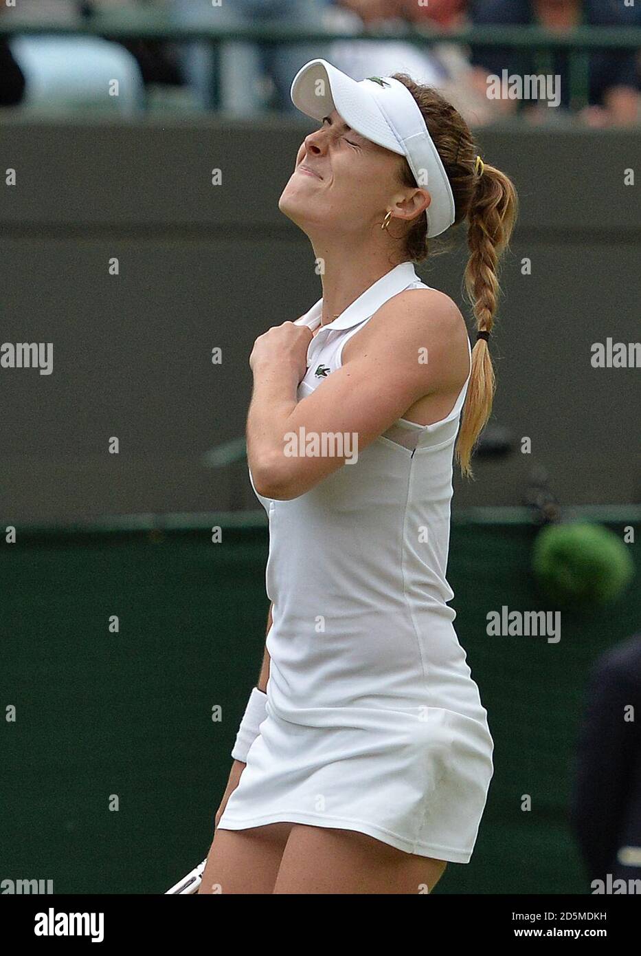 Alize Cornet of France celebrates beating Serena Williams of the