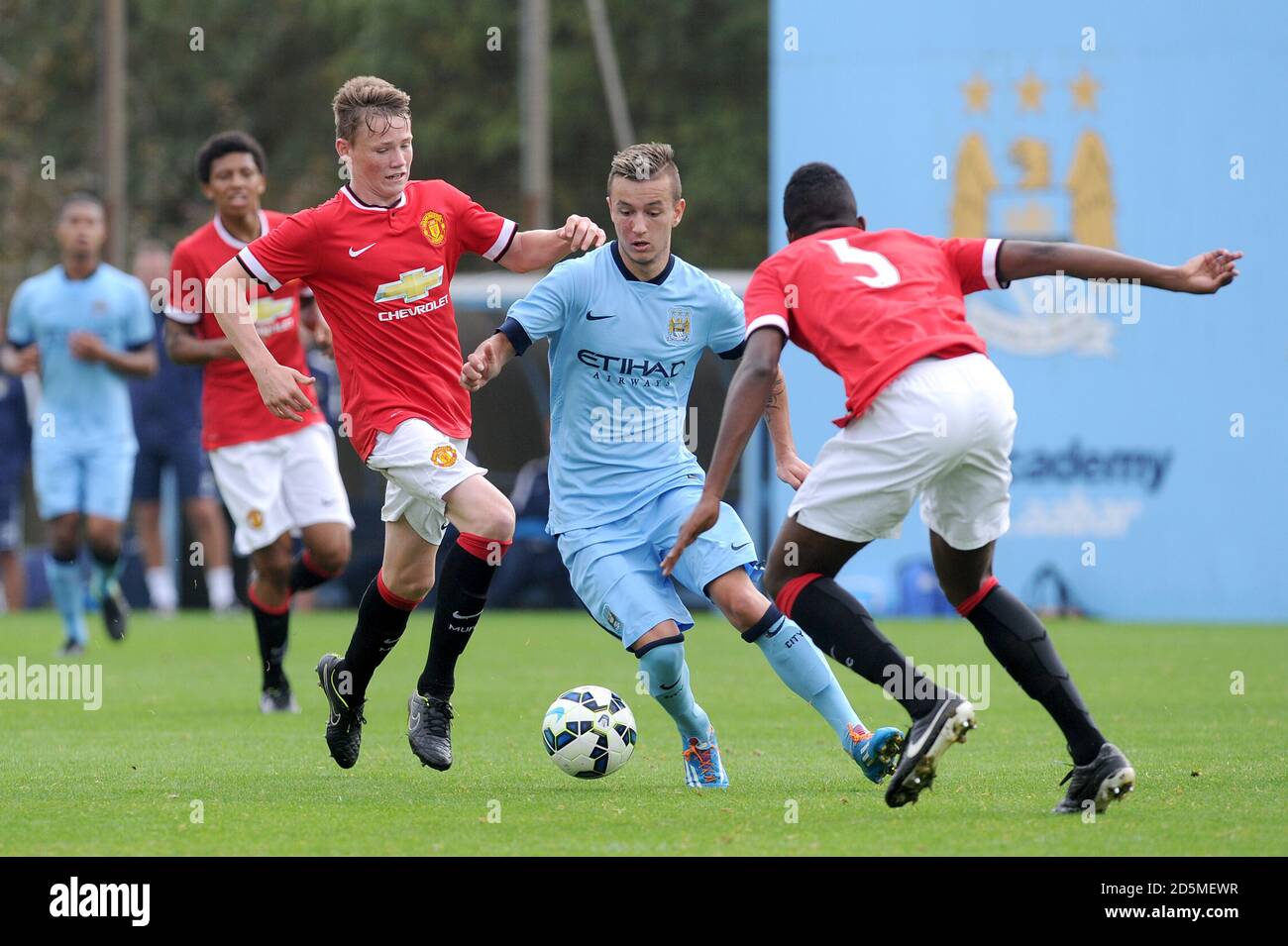 Manchester City's Bersant Celina (centre) takes on Manchester United's Scott McTominay (left) and Ro-Shaun Williams Stock Photo