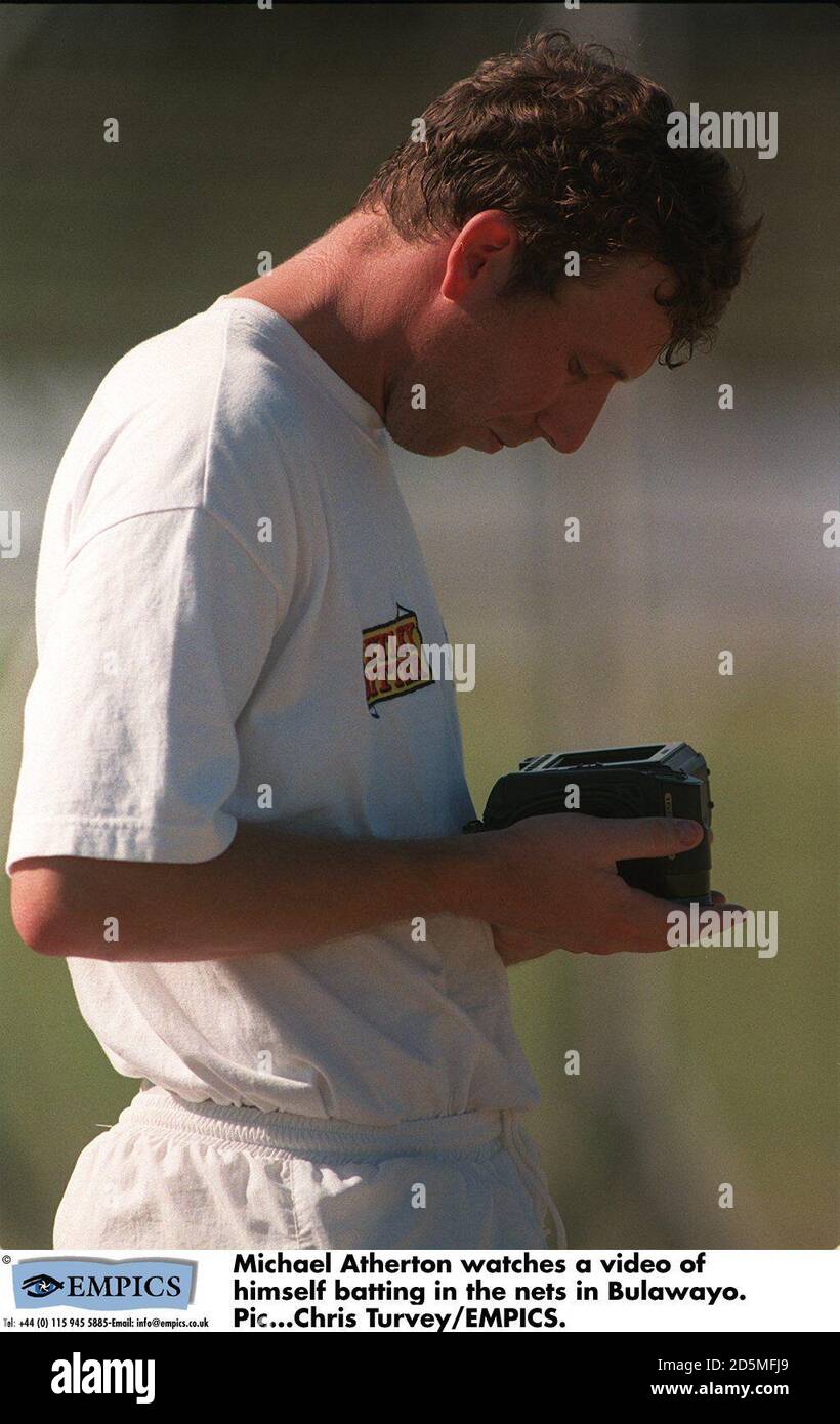 Michael Atherton watches a video of himself batting in the nets at the