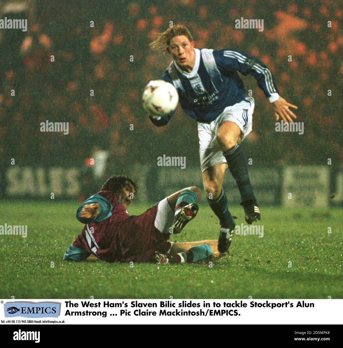 The West Ham's Slaven Bilic slides in to tackle Stockport's Alun Armstrong Stock Photo