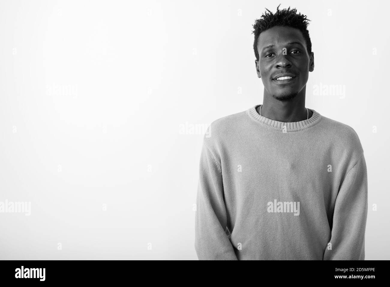 Studio shot of young happy black African man smiling against white ...