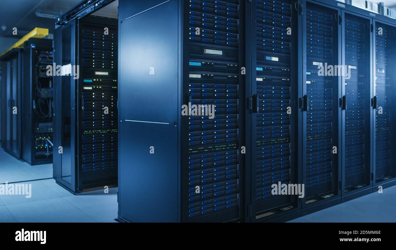 Shot of Modern Data Center With Multiple Rows of Operational Server Racks. Modern High-Tech Database Super Computer Clean Room. Stock Photo