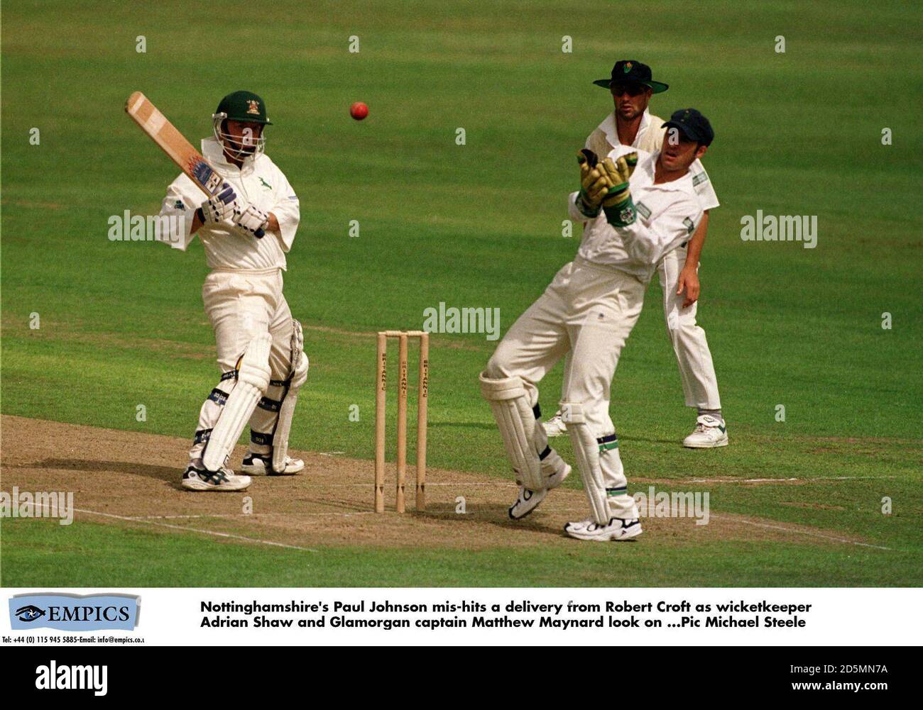 Nottinghamshire's Paul Johnson mis-hits a delivery from Robert Croft as wicketkeeper Adrian Shaw and Glamorgan captain Matthew Maynard look onr Stock Photo