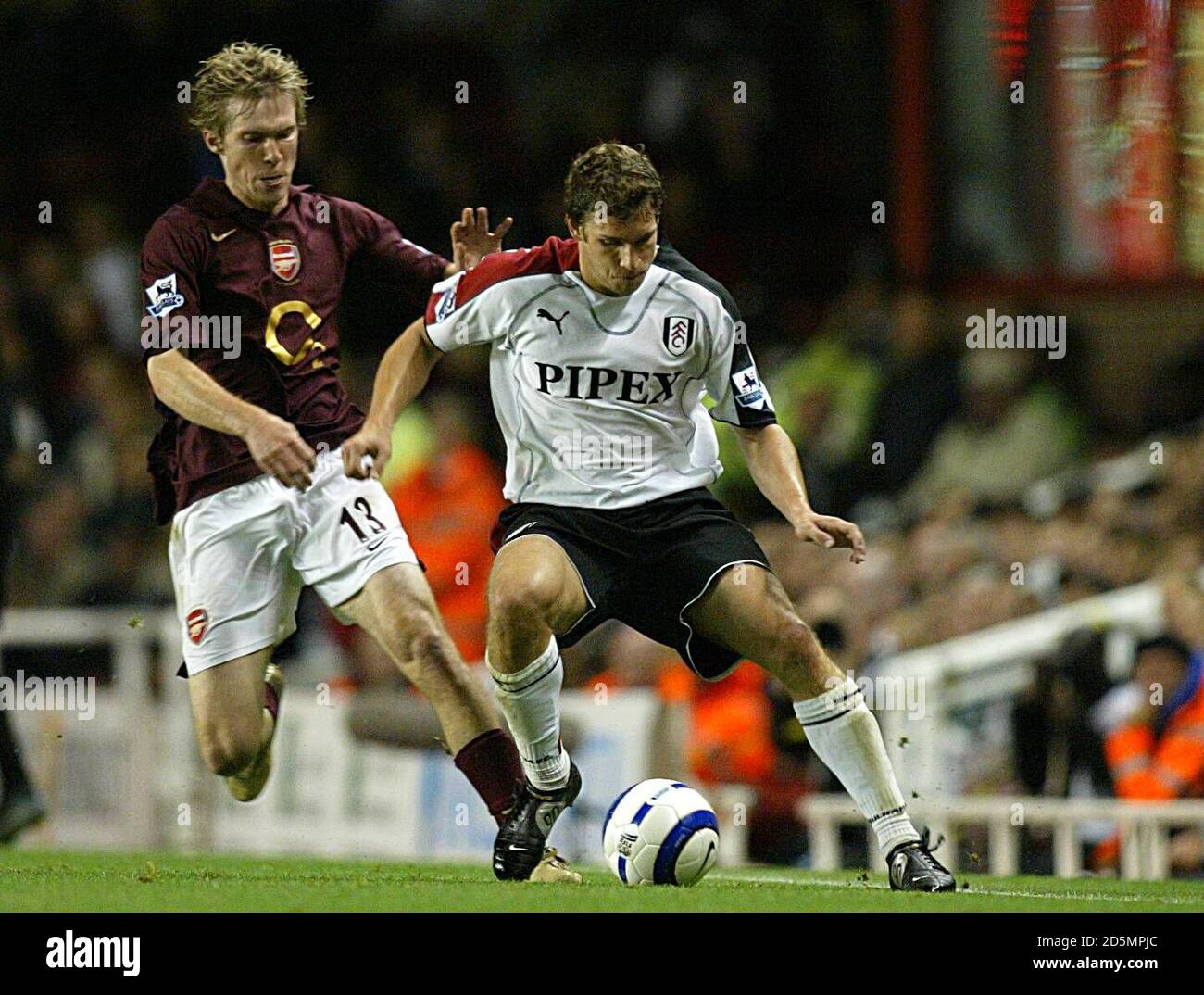 Arsenal's Aleksander Hleb and Fulham's Moritz Volz battle for the ball Stock Photo