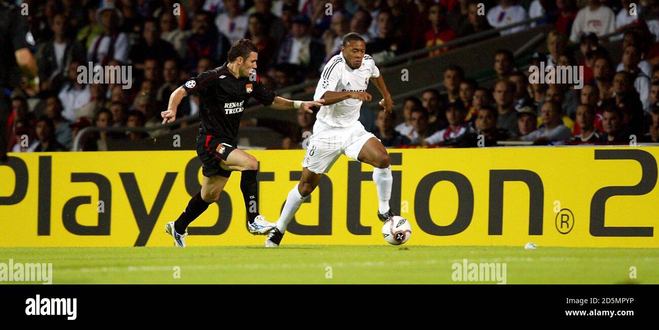 Olympique Lyonnais' Antony Reveillere and Real Madrid's Julio Baptista Stock Photo