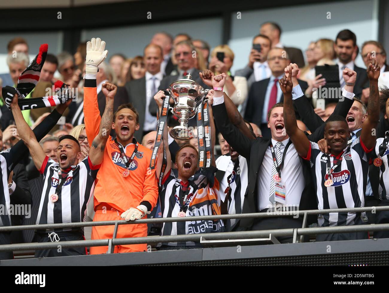 Grimsby Town's Captain Craig Disley lifts the trophy after their win
