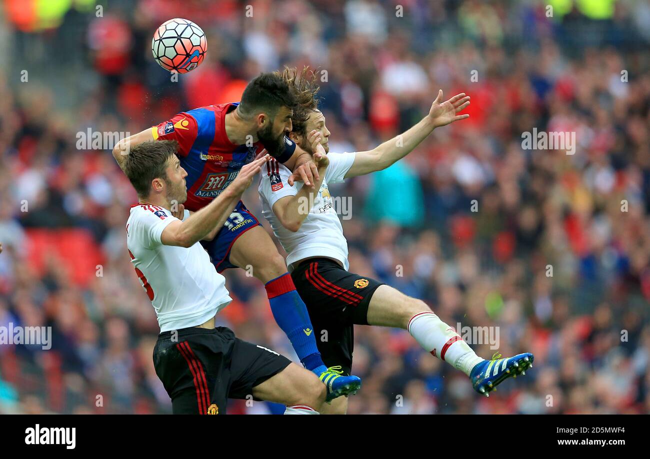 Crystal Palace's Mile Jedinak battles for the ball with Manchester United's Michael Carrick (left) and Manchester United's Daley Blind (right)  Stock Photo