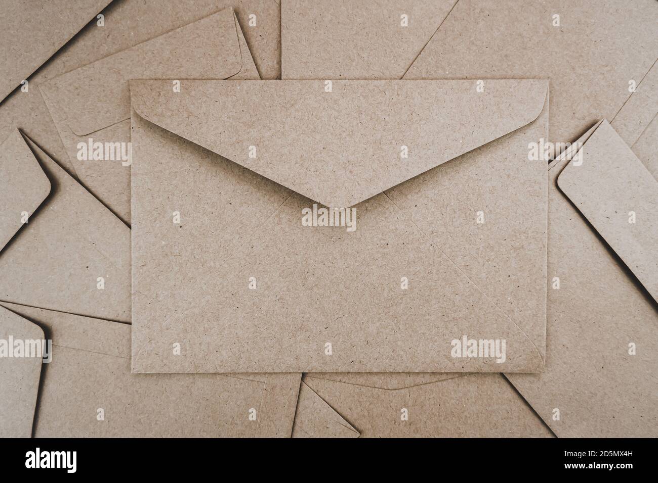 Top view of Brown paper envelope. Flat lay of Many brown paper envelopes overlaid. Stationery minimalism style. Stock Photo