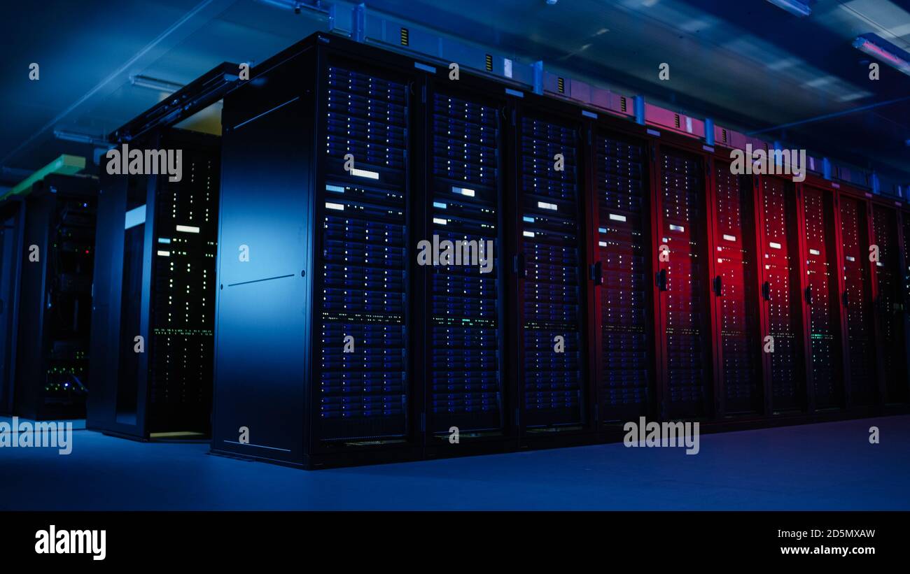 Shot of Data Center With Multiple Rows of Fully Operational Server Racks. Modern Telecommunications, Artificial Intelligence, Supercomputer Technology Stock Photo