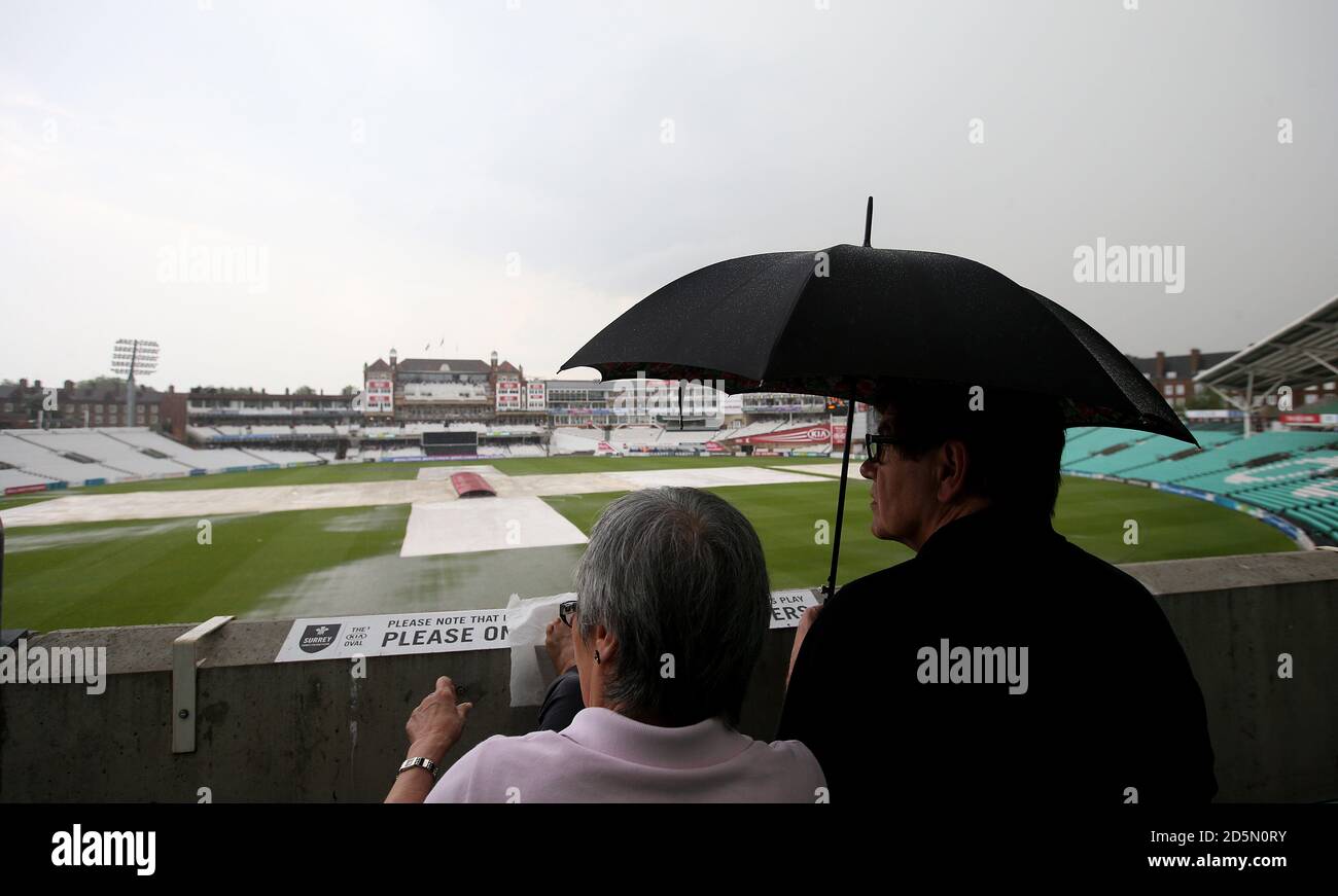 General View Of Spectators Under An Umbrella As Rain Stop Play Stock ...