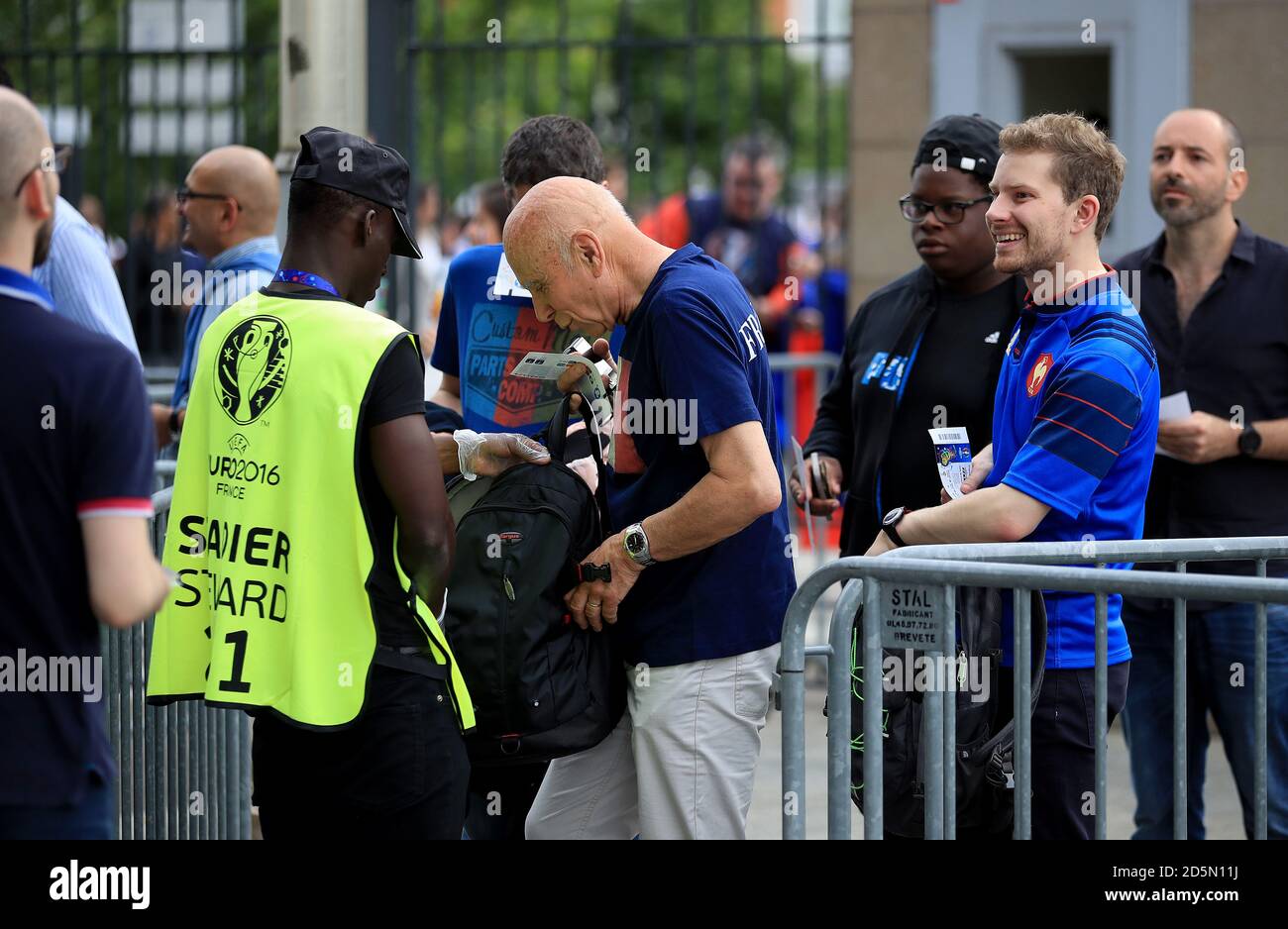 Fans are searched by security before entering the stadium Stock Photo