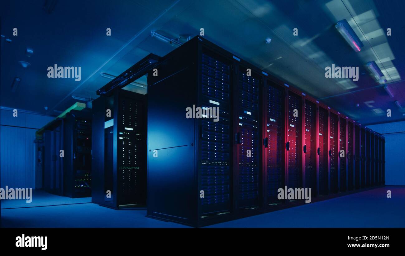 Shot of Data Center With Multiple Rows of Fully Operational Server Racks. Modern Telecommunications, Cloud Computing, Artificial Intelligence Stock Photo