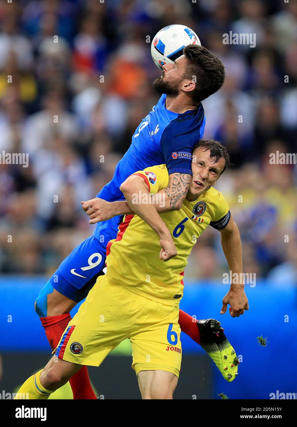 Romania's Vlad Chiriches (bottom) and France's Olivier Giroud (top) battle for the ball Stock Photo