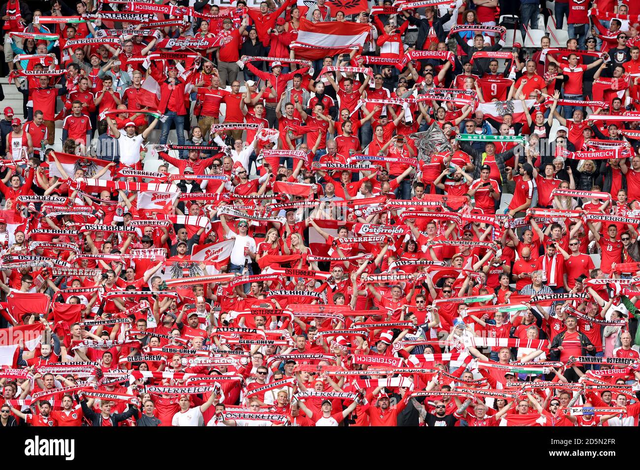 Fans of Ferencvarosi show their support as they hold scarves prior