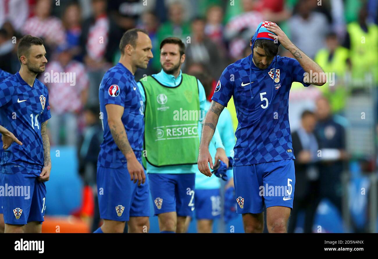 Croatia's Vedran Corluka (right) leaves the pitch dejected after the final whistle.  Stock Photo