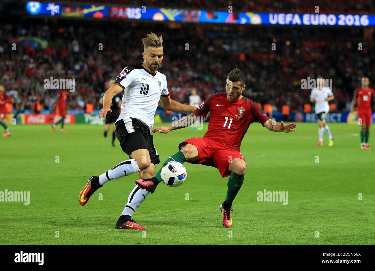 Austria's Lukas Hinterseer (left) and Portugal's Vieirinha battle for the ball. Stock Photo