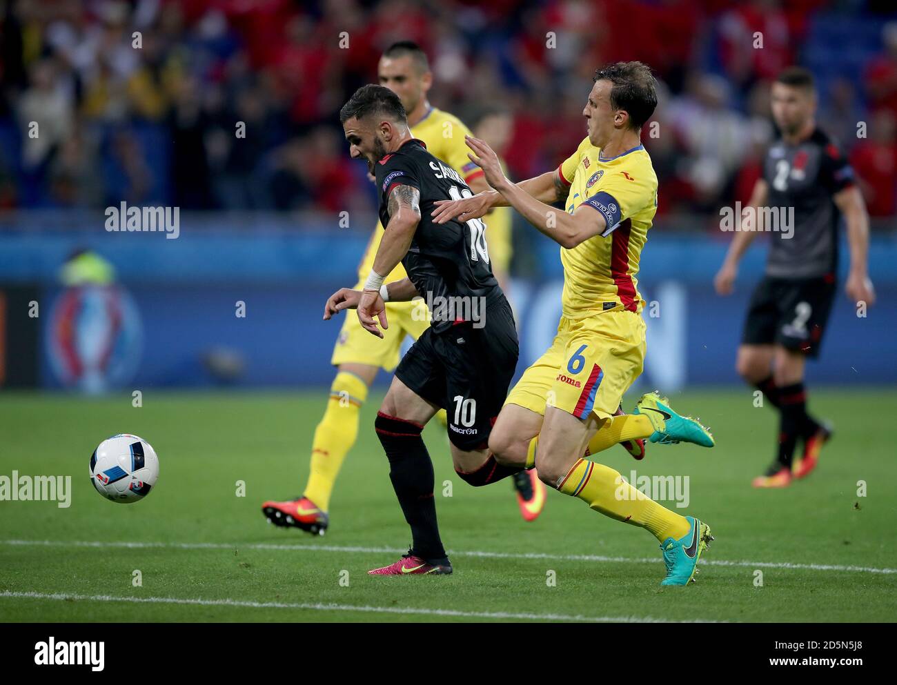 Romania's Vlad Chiriches (right) and Albania's Armando Sadiku battle for the ball Stock Photo