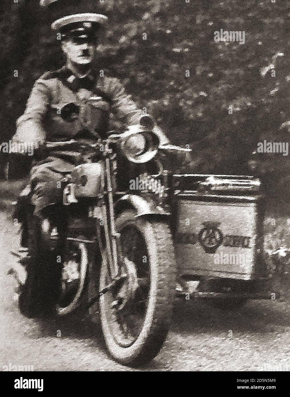 1932 (An old snapshot photo ) Uniformed motorcycle (mechanic) patrolmen replaced the old AA cycle Scouts. Historically on 19 June 1905, Charles Jarrott and Walter Gibbons, Charles Jarrott, Ludwig Schlentheim & Alfred Harrismet met at the Lyons Trocadero Restaurant in Shaftesbury Avenue, London ,to form the 'The Motorists' Mutual Association', (MMA).Just a week later, on 26 June, the MMA committee changed its name to The Automobile Association. Stock Photo