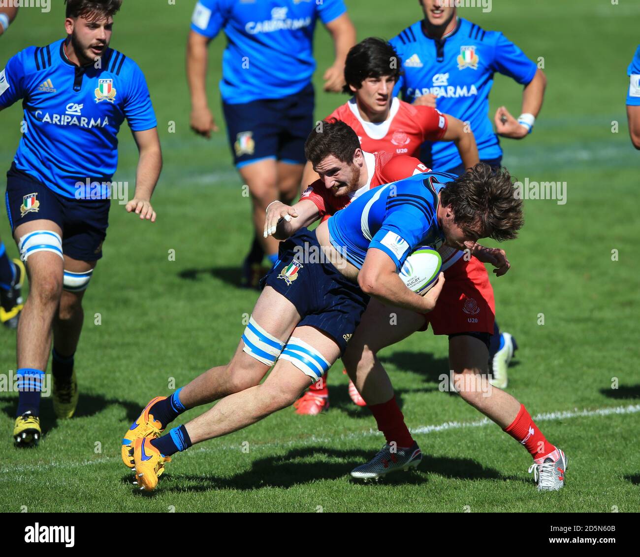 Vasil Lobzhanidze tackles Italy's Giovannia Pettinelli (front