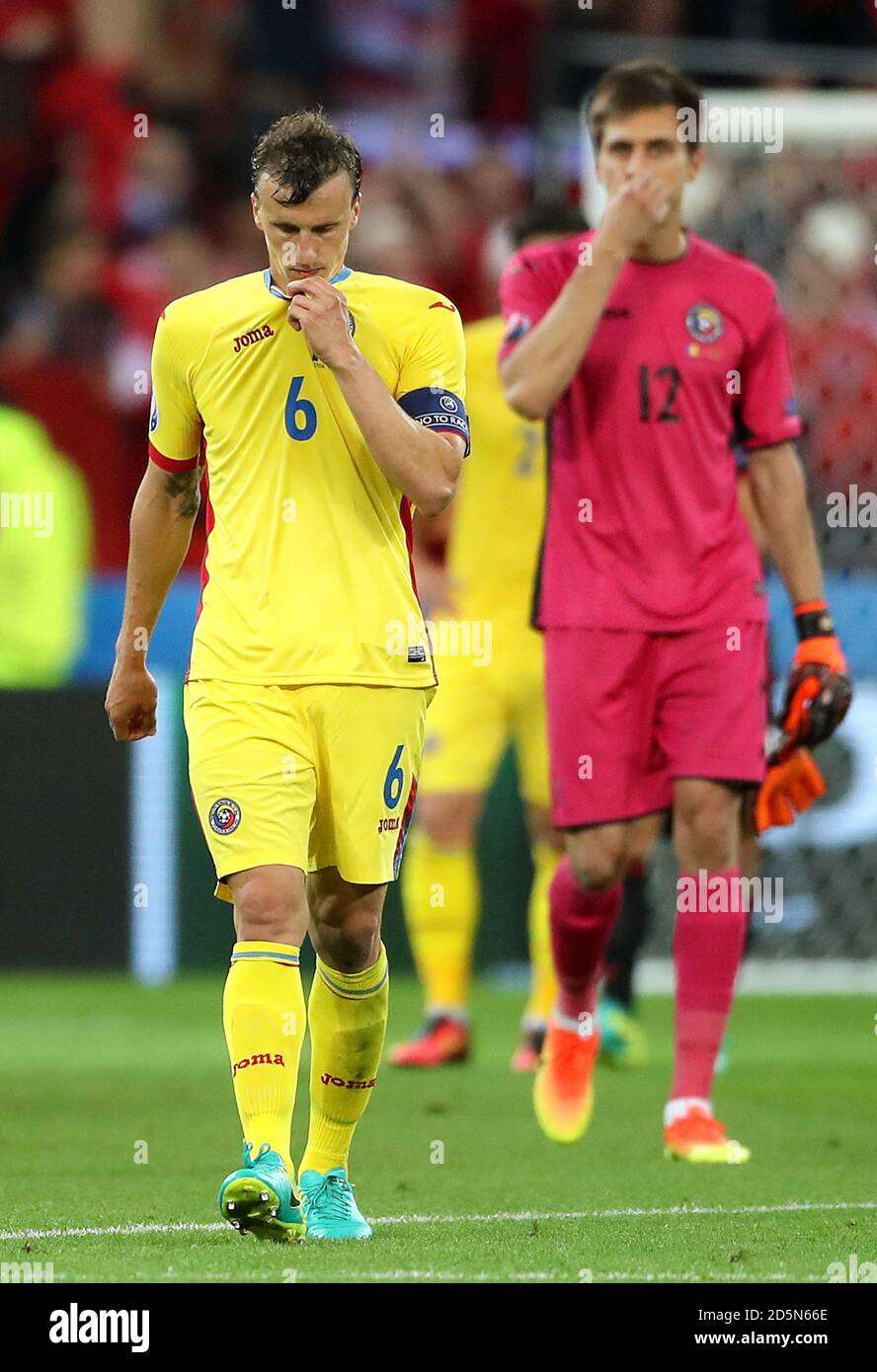 Romania's Vlad Chiriches (left) walks off the pitch dejected after the game. Stock Photo