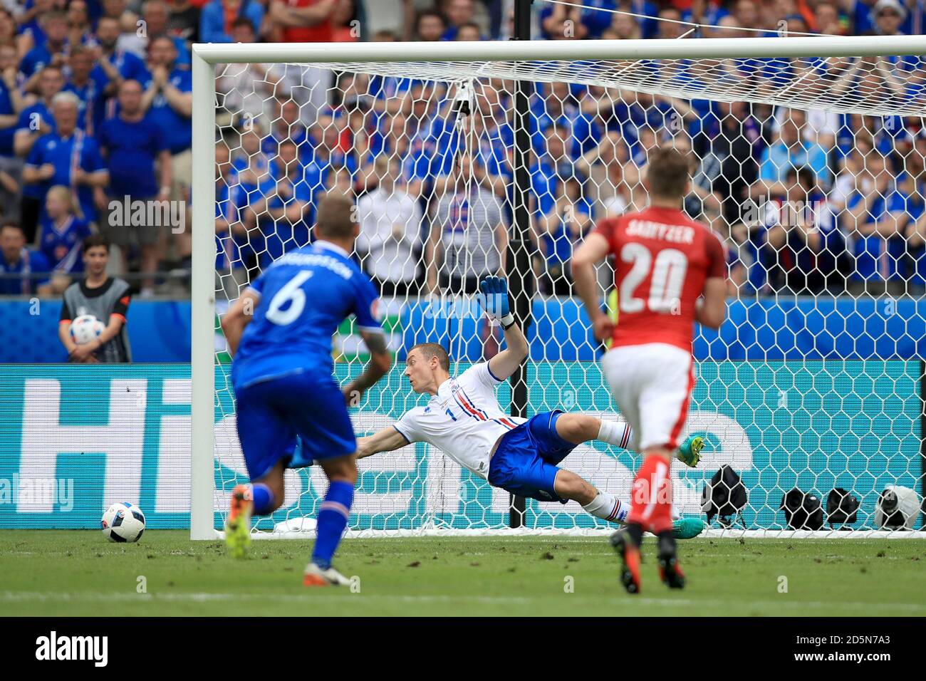 Iceland goalkeeper Hannes Thor Halldorsson (centre) watches Austria's Aleksandar Dragovic (not in picture) penalty kick hit the post and go wide Stock Photo