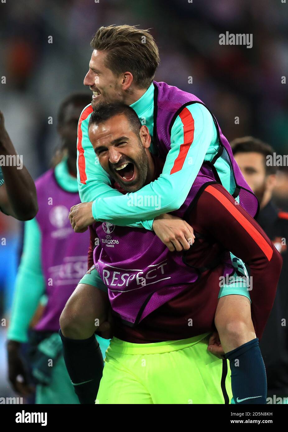Portugal goalkeeper Eduardo (bottom) celebrates with Adrien Silva Stock Photo