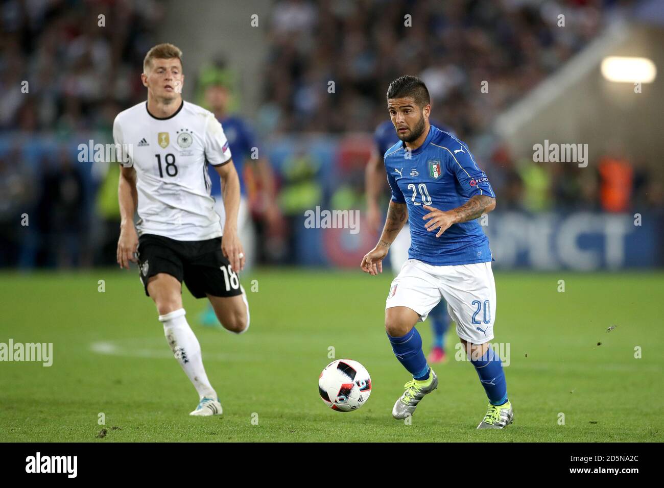 Italy's Lorenzo Insigne and Germany's Toni Kroos (left) in action Stock Photo